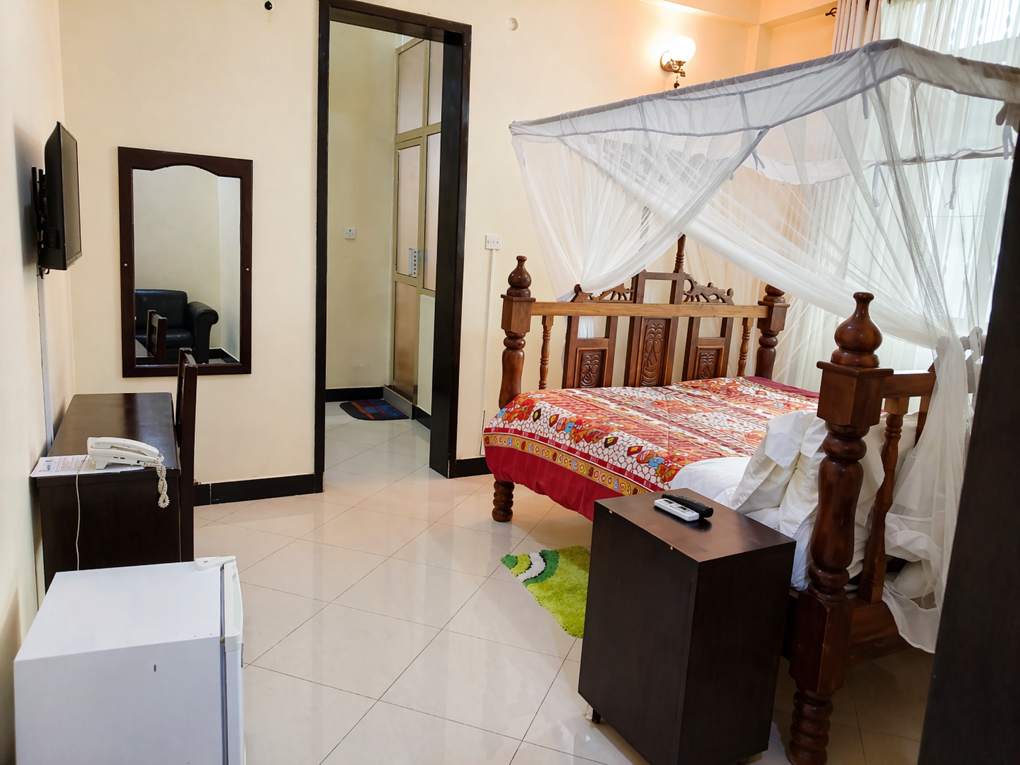 Luxury room with comfortable bed at Hedaru Palace Hotel